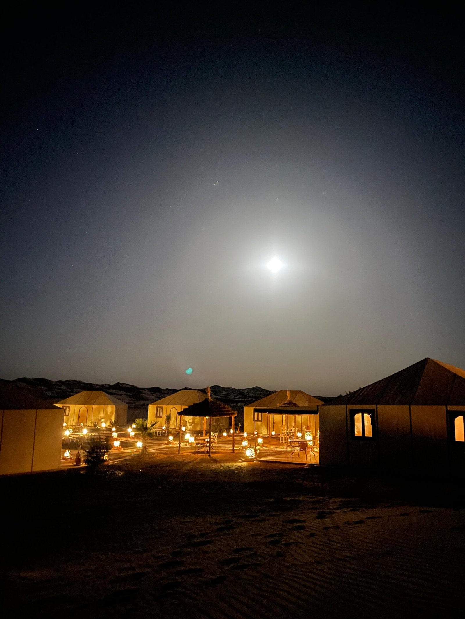 Guests on a Morocco desert tour near Merzouga dunes at sunset